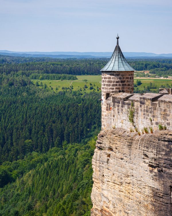 A beautiful shot of Koenigstein Fortress surrounded by scenic forest landscape in Germany